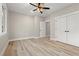 Cozy bedroom featuring a ceiling fan, wood-look floors, large window and closet at 1001 Brantley L Brantley Ln., North Myrtle Beach, SC 29582