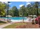 Large community pool surrounded by lounge chairs, umbrellas, and lush greenery at 1001 Brantley L Brantley Ln., North Myrtle Beach, SC 29582