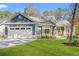Well-maintained home with a two-car garage, green lawn, and craftsman-style front porch at 1001 Brantley L Brantley Ln., North Myrtle Beach, SC 29582