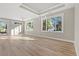 Spacious living room filled with natural light, beautiful hardwood floors, and large windows at 1001 Brantley L Brantley Ln., North Myrtle Beach, SC 29582