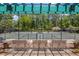 View of tennis courts with shaded seating and surrounded by lush greenery at 1001 Brantley L Brantley Ln., North Myrtle Beach, SC 29582