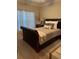 Well-lit bedroom featuring a comfortable leather sleigh bed and serene decor, perfect for relaxation at 1001 Ray Costin Way # 1605, Murrells Inlet, SC 29576