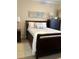 Charming bedroom featuring a dark wood sleigh bed and dresser, illuminated by two lamps with lots of light at 1001 Ray Costin Way # 1605, Murrells Inlet, SC 29576