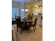 Cozy dining area features a round wooden table, four chairs, and a stylish chandelier at 1001 Ray Costin Way # 1605, Murrells Inlet, SC 29576
