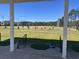 Wide view of golf driving range, viewed from covered shelter, under clear blue skies at 1001 Ray Costin Way # 1605, Murrells Inlet, SC 29576