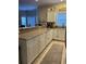 Well-appointed kitchen with granite countertops, white cabinetry, modern appliances, and tiled floor at 1001 Ray Costin Way # 1605, Murrells Inlet, SC 29576
