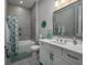 Modern bathroom featuring a shower-tub combination with stylish gray tiling and white vanity at 1004 Marsh View Dr., North Myrtle Beach, SC 29582