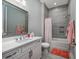 Bright bathroom with white cabinets, a large mirror, and a shower-tub combination with gray tile at 1004 Marsh View Dr., North Myrtle Beach, SC 29582