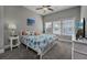 Charming bedroom with coastal-themed bedding, a ceiling fan, and ample natural light at 1004 Marsh View Dr., North Myrtle Beach, SC 29582