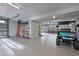 Spacious garage with epoxy flooring, an organized shelving system, and a golf cart at 1004 Marsh View Dr., North Myrtle Beach, SC 29582