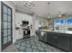 Modern kitchen featuring stainless steel appliances, sleek cabinetry, an island, and an adjacent living area at 1004 Marsh View Dr., North Myrtle Beach, SC 29582
