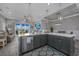 Open-concept kitchen with island seating, stainless steel appliances, and seamless flow to the living and dining areas at 1004 Marsh View Dr., North Myrtle Beach, SC 29582