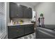 Well-equipped laundry room with gray cabinetry, a sink, and modern appliances at 1004 Marsh View Dr., North Myrtle Beach, SC 29582