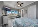 Bright main bedroom featuring large windows, a ceiling fan, and wood-look floors at 1004 Marsh View Dr., North Myrtle Beach, SC 29582