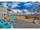 Charming brick patio area with four Adirondack chairs offering gorgeous views of the surrounding landscape at 1004 Marsh View Dr., North Myrtle Beach, SC 29582