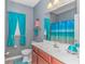 Bathroom featuring turquoise accents, a vanity with wood cabinets, and ocean themed decoration at 110 Echaw Dr., Conway, SC 29526