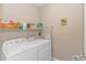 Functional laundry room with washer, dryer, and shelving for organized storage of household supplies at 110 Echaw Dr., Conway, SC 29526