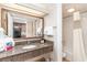 Well-lit bathroom featuring granite countertop, large mirror, and shower with white curtain at 1105 S Ocean Blvd. # 220, Myrtle Beach, SC 29577