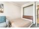 Small bedroom with pull down bed, side chair and neutral colors for a restful space at 1105 S Ocean Blvd. # 220, Myrtle Beach, SC 29577
