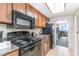 A kitchen featuring a stovetop and microwave with a view looking toward the living room and ocean balcony at 1105 S Ocean Blvd. # 220, Myrtle Beach, SC 29577