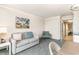 Comfortable living room with a sofa, a chair, and access to another room with tile floors at 1105 S Ocean Blvd. # 220, Myrtle Beach, SC 29577