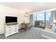 A living room with table and seating next to a sliding glass door with balcony and ocean views at 1105 S Ocean Blvd. # 220, Myrtle Beach, SC 29577