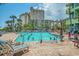 Outdoor swimming pool with many people and lounge chairs at 1105 S Ocean Blvd. # 220, Myrtle Beach, SC 29577