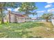 Backyard with a lush green lawn, mature trees, and white picket fence at 111 S Poplar Dr., Surfside Beach, SC 29575
