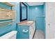 Bathroom features a toilet, vanity, and blue walls with basket-style decorations at 111 S Poplar Dr., Surfside Beach, SC 29575