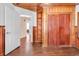 Bedroom features wood paneling, hardwood floors, built in shelves and an open doorway at 111 S Poplar Dr., Surfside Beach, SC 29575