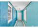 Hallway with tile floor, many windows and vibrant color scheme at 111 S Poplar Dr., Surfside Beach, SC 29575