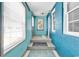 Hallway with tile floor, many windows and vibrant color scheme at 111 S Poplar Dr., Surfside Beach, SC 29575