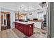 Spacious kitchen with white cabinets, stainless steel appliances, and a marble countertop island at 111 S Poplar Dr., Surfside Beach, SC 29575