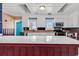 Bright kitchen with white cabinets, stainless steel appliances, and a white marble-look island at 111 S Poplar Dr., Surfside Beach, SC 29575