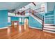 Open living room boasting hardwood floors, staircase and fireplace at 111 S Poplar Dr., Surfside Beach, SC 29575