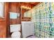Bathroom with white vanity, cactus themed shower curtain, and wood paneled walls at 112 S Rosemary Ave., Andrews, SC 29510