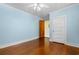 Bedroom with light-blue paneled walls and hard wood-look floors at 112 S Rosemary Ave., Andrews, SC 29510