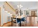 Open dining area featuring hardwood floors, staircase and connection to living area at 112 S Rosemary Ave., Andrews, SC 29510