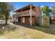 Back of red brick house with open wood balcony and fenced yard at 112 S Rosemary Ave., Andrews, SC 29510