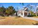 Two-story home with a carport and screened porch in a grassy yard at 112 S Rosemary Ave., Andrews, SC 29510