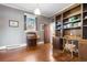 Office featuring hardwood floors, built-in bookshelves and a desk at 112 S Rosemary Ave., Andrews, SC 29510