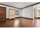 A spacious room with hardwood floors and a large window at 112 S Rosemary Ave., Andrews, SC 29510
