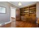Inviting living room featuring hardwood floors, built-in shelving and classic patterned wallpaper at 112 S Rosemary Ave., Andrews, SC 29510