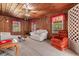 Cozy living room with wood paneled walls, a ceiling fan, and comfortable seating arrangements at 112 S Rosemary Ave., Andrews, SC 29510