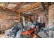 Unfinished storage area with exposed brick, wood beams, and a variety of equipment at 112 S Rosemary Ave., Andrews, SC 29510
