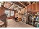 Unfinished storage area with exposed brick walls and a variety of ladders, tools and building supplies at 112 S Rosemary Ave., Andrews, SC 29510