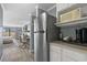 Modern kitchen featuring stainless steel refrigerator, neutral countertop, and wood-look flooring at 1207 Ocean Blvd. S # 50801, Myrtle Beach, SC 29577