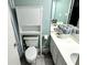 Inviting bathroom featuring dual sinks, a basket of towels, and a storage cabinet over the toilet at 1207 S Ocean Blvd. # 51104, Myrtle Beach, SC 29577