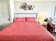 A cozy bedroom featuring a full bed with a headboard and two pillows with an end table and lamp at 1207 S Ocean Blvd. # 51104, Myrtle Beach, SC 29577