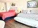 Well-lit bedroom showing coral bed, a patterned daybed, and a neutral wall color at 1207 S Ocean Blvd. # 51104, Myrtle Beach, SC 29577